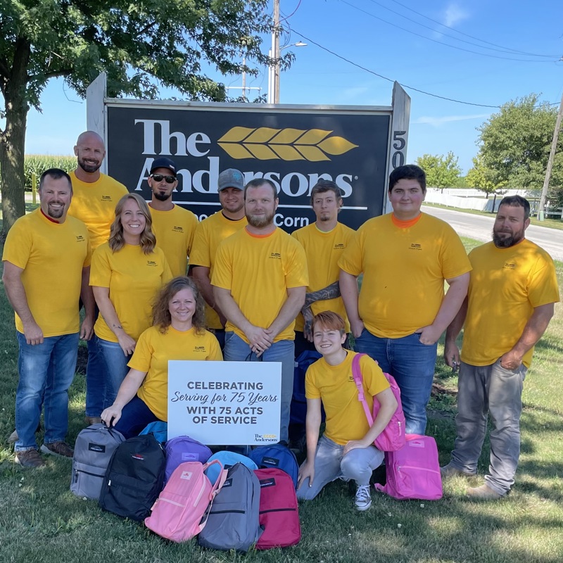 Employees in yellow shirts with backpacks 
