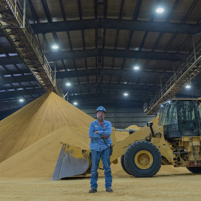 Individual standing in the DDG building at an ethanol plant location