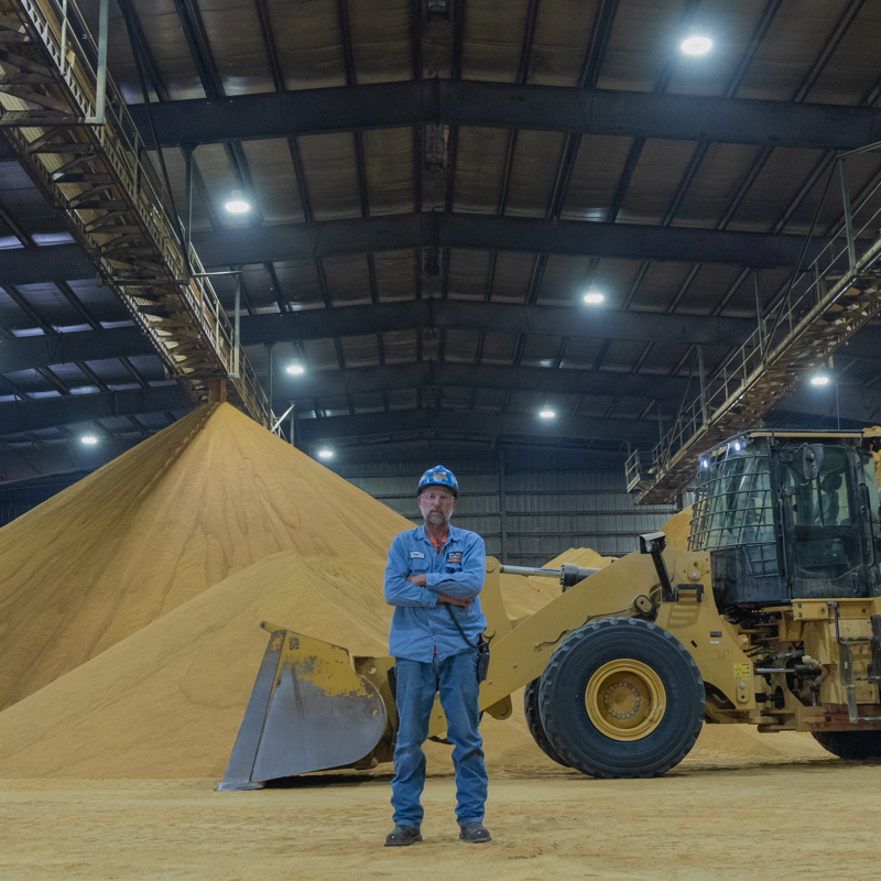 Individual standing in the DDG building at an ethanol plant location