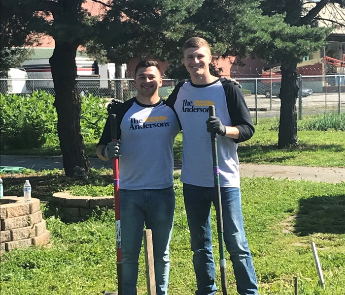 Two individuals volunteering at a community garden