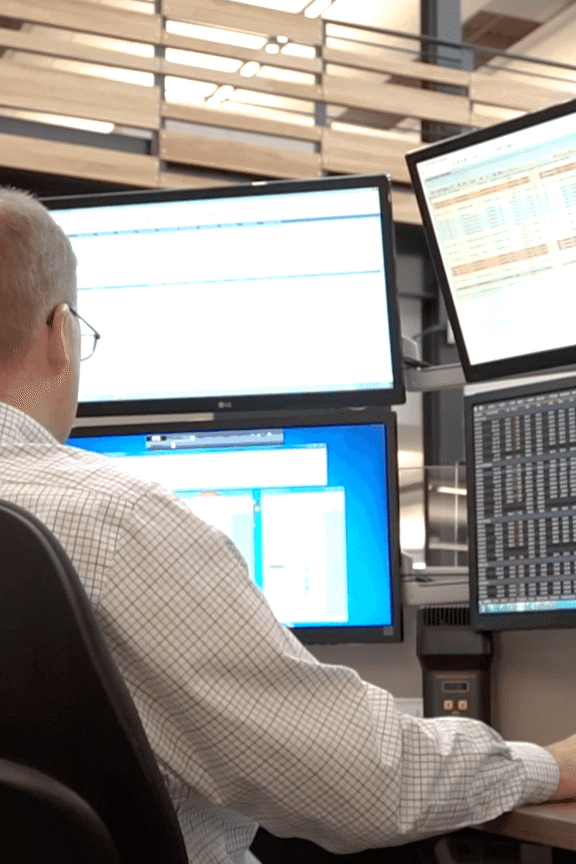 Trader working at their desk with multiple monitors