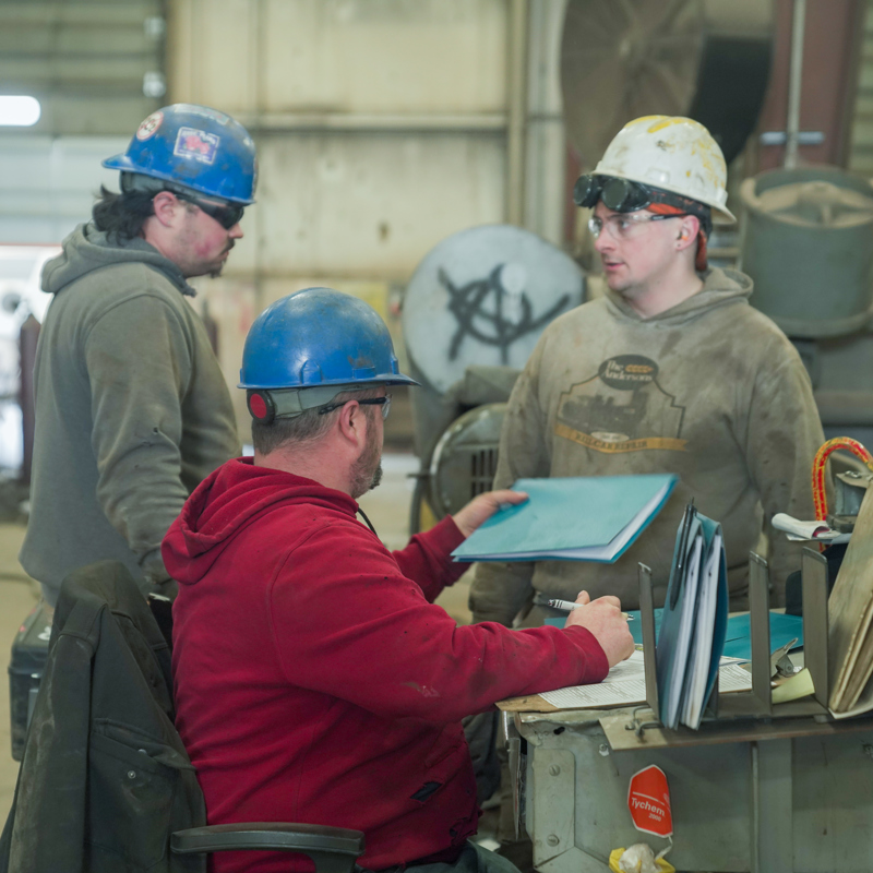 Three individuals working together at The Andersons Fabrication Shop