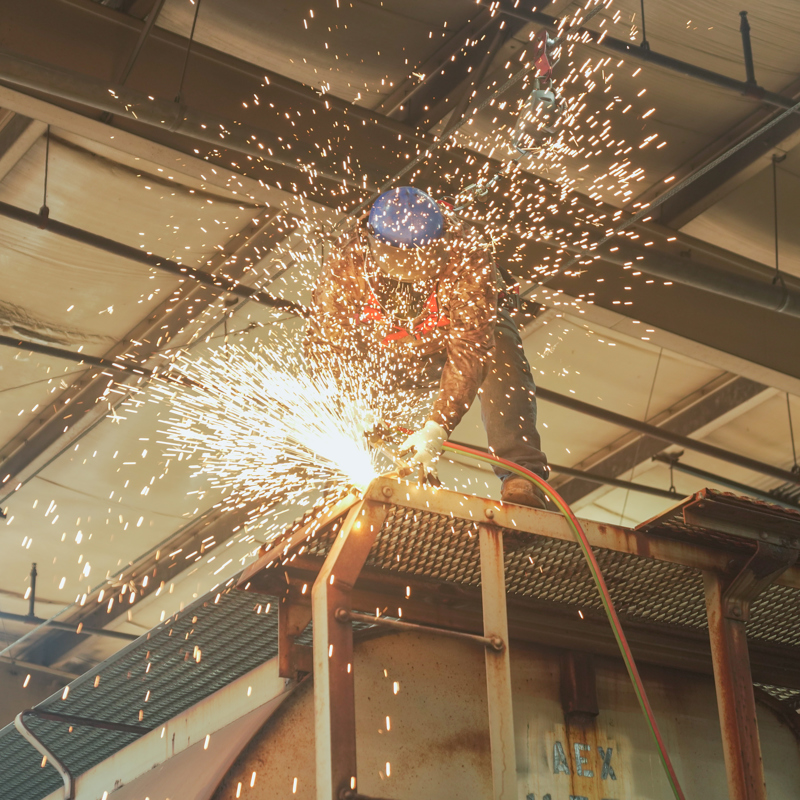 Welder working on a railcar at The Andersons Fabrication Shop