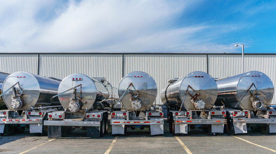 Several tanker trucks parked in a row