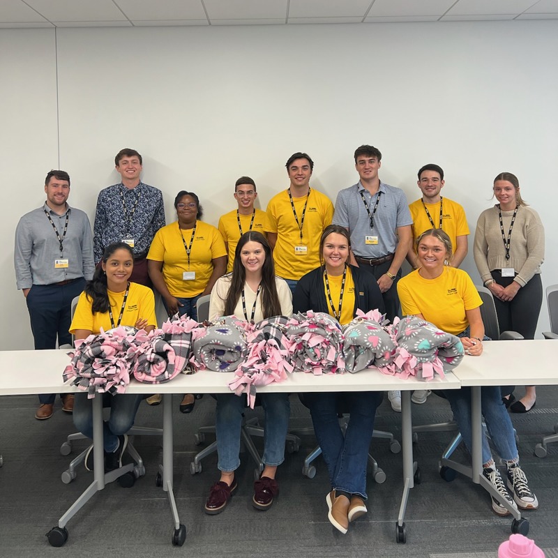 Interns posing with fleece blankets