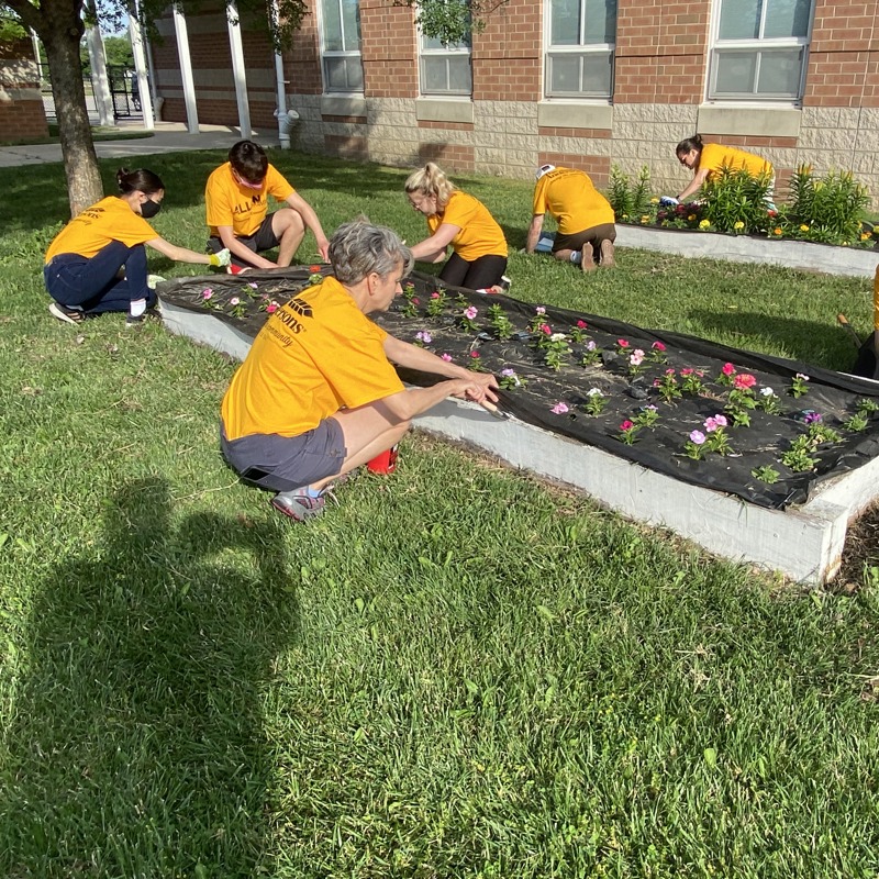 Individuals volunteering at a community garden