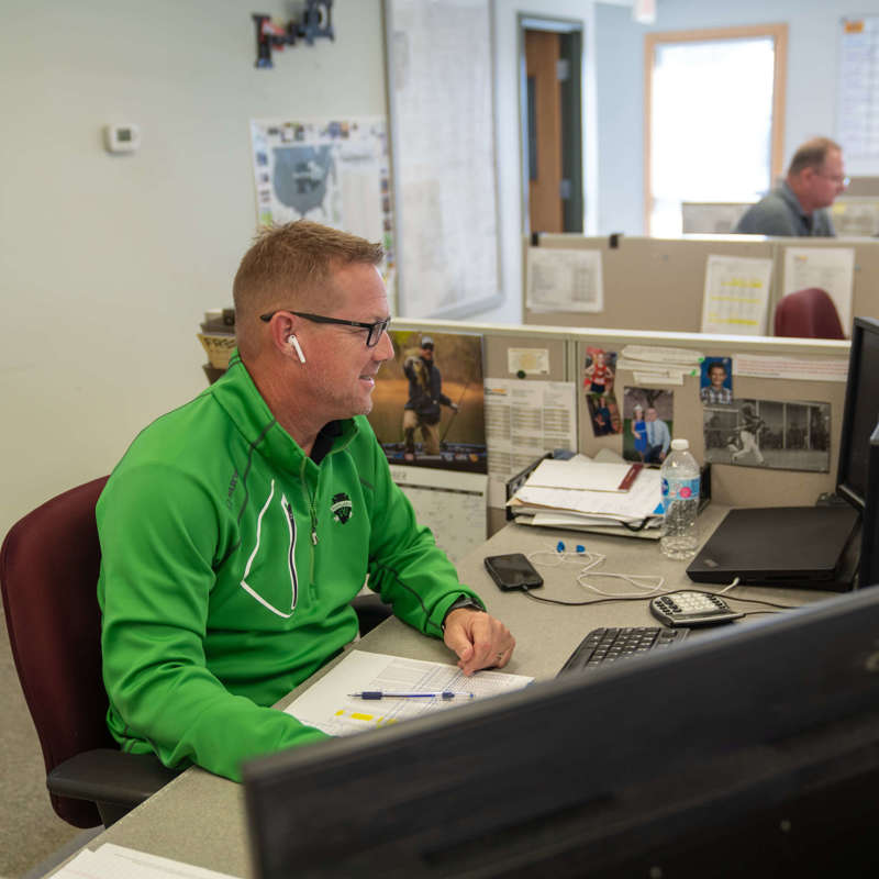 Individuals working at their desks in a trading office