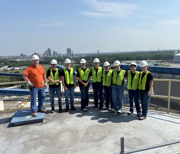 Group of interns wearing PPE on top of grain elevator 