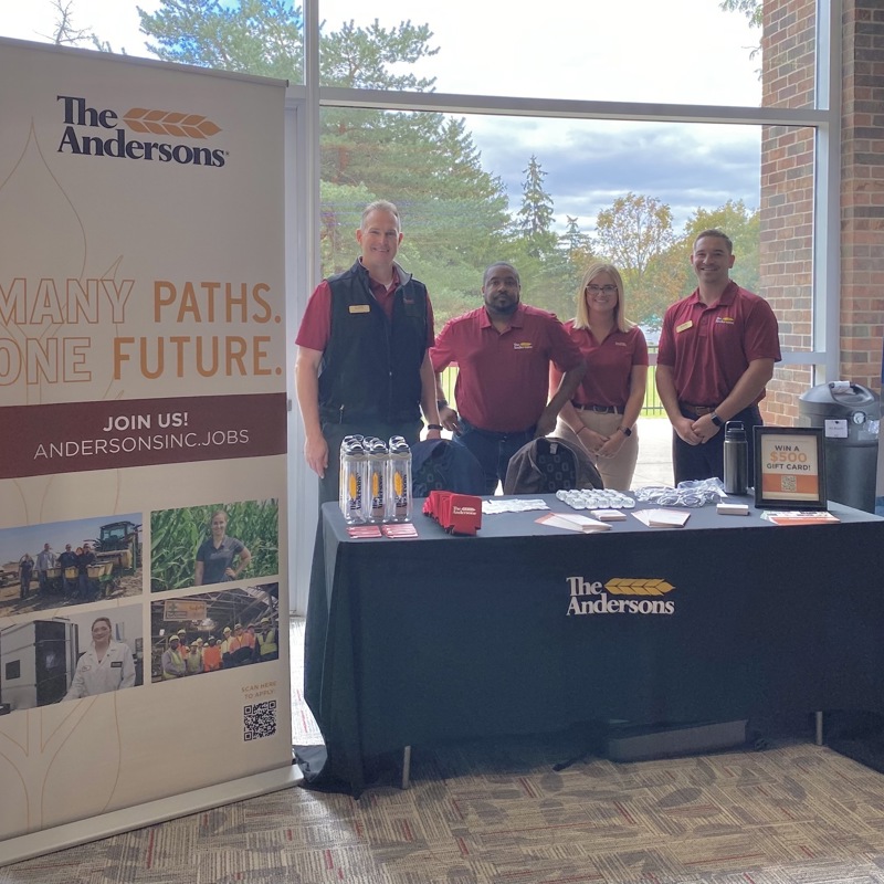 Four recruiters at a booth for The Andersons